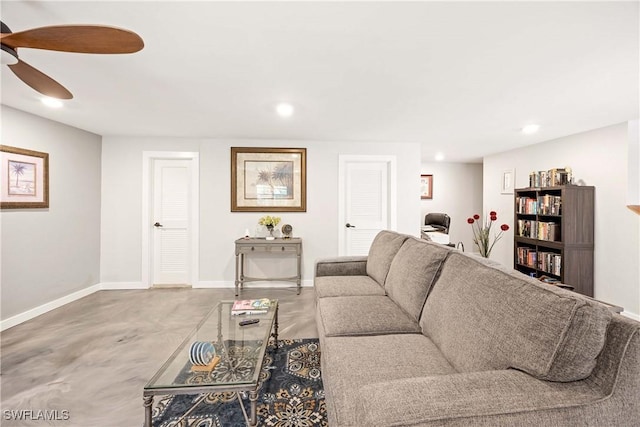 living room with ceiling fan and concrete floors