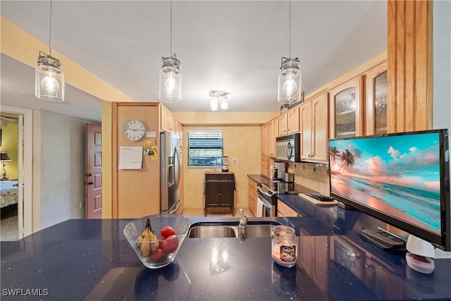 kitchen featuring backsplash, decorative light fixtures, and stainless steel appliances