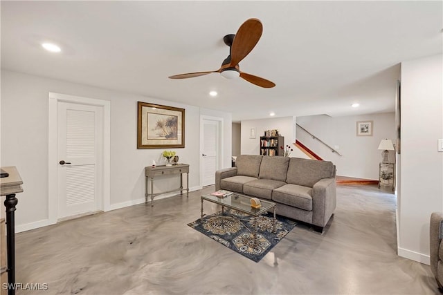 living room with ceiling fan and concrete floors