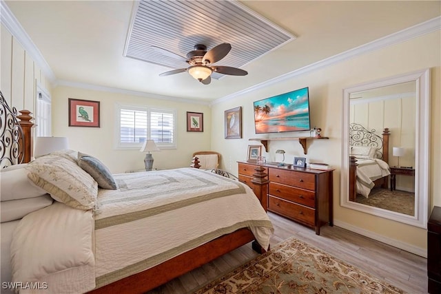 bedroom featuring ceiling fan, light wood-type flooring, and ornamental molding