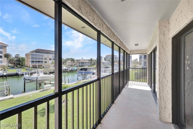 sunroom / solarium featuring a water view