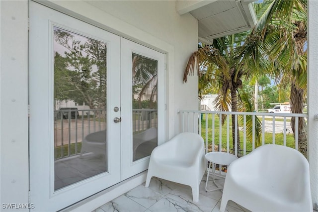 exterior space featuring beam ceiling and french doors