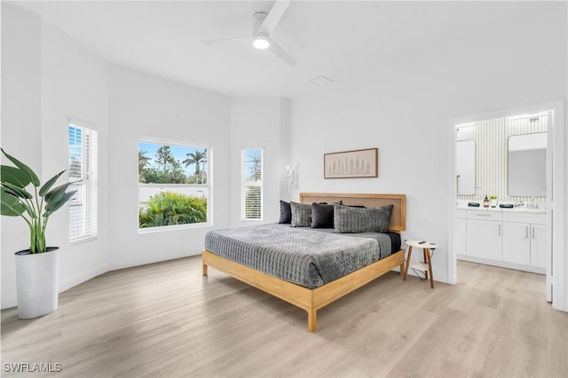 bedroom featuring ensuite bathroom, ceiling fan, and light hardwood / wood-style flooring