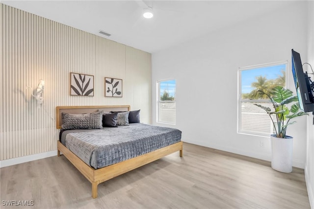 bedroom with light wood-type flooring and ceiling fan