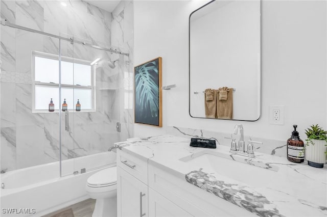 full bathroom featuring toilet, enclosed tub / shower combo, and vanity