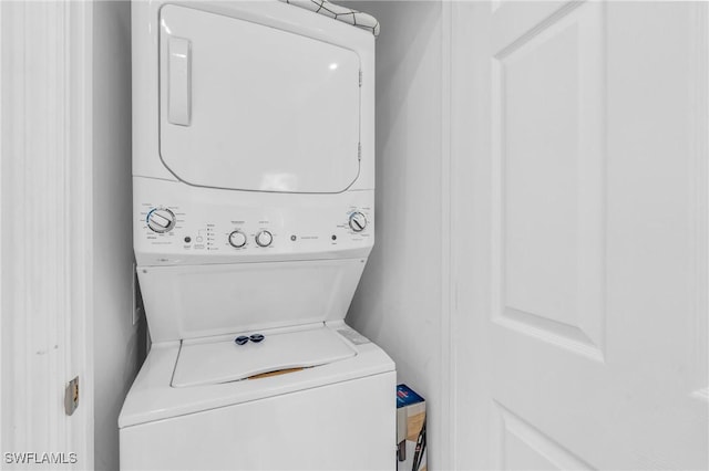 washroom featuring stacked washing maching and dryer