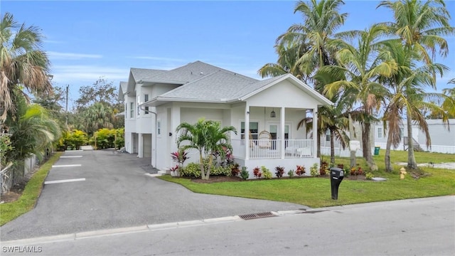 view of front of home featuring a front yard and covered porch