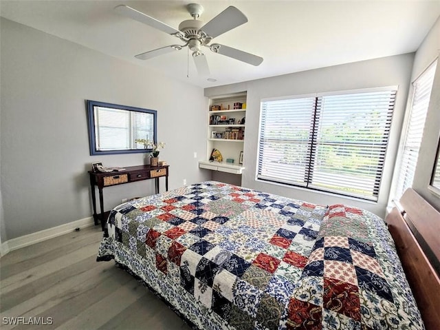 bedroom with ceiling fan and wood-type flooring