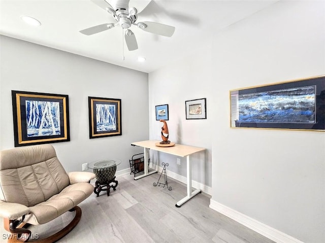 home office with ceiling fan and light hardwood / wood-style floors