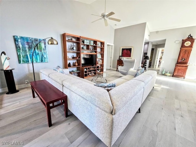 living room with light wood-type flooring and ceiling fan