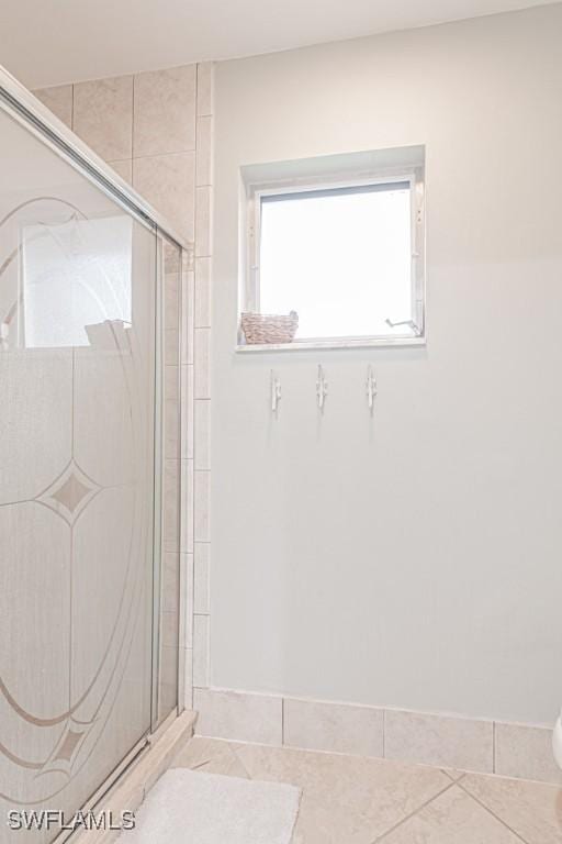 bathroom featuring tile patterned flooring and an enclosed shower