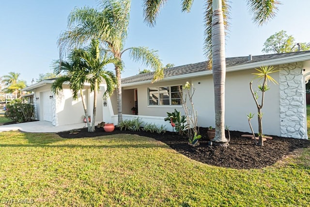 ranch-style house featuring a garage and a front yard