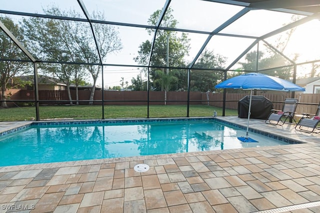 view of swimming pool with glass enclosure, a grill, a yard, and a patio