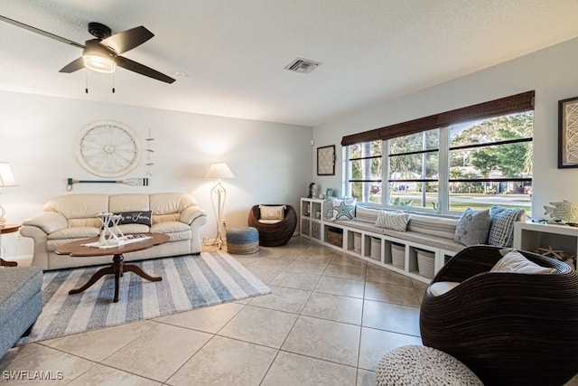 tiled living room with ceiling fan