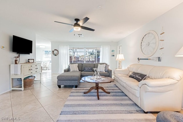 tiled living room featuring ceiling fan