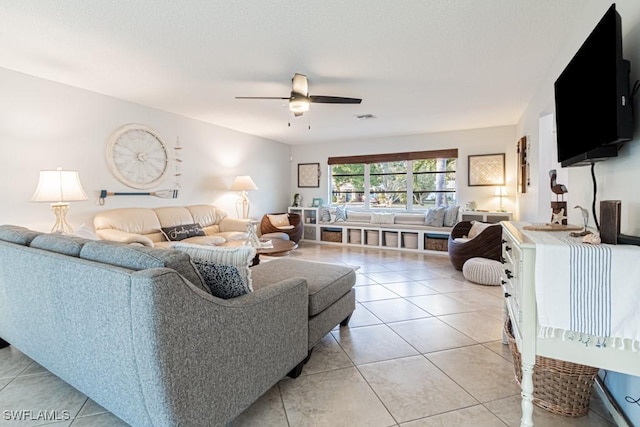 living room featuring ceiling fan and light tile patterned flooring