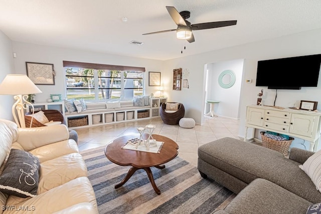 living room with ceiling fan and light tile patterned floors