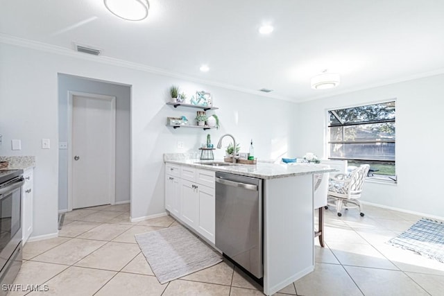 kitchen featuring light stone countertops, a kitchen breakfast bar, stainless steel dishwasher, sink, and white cabinetry