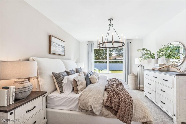 carpeted bedroom with an inviting chandelier