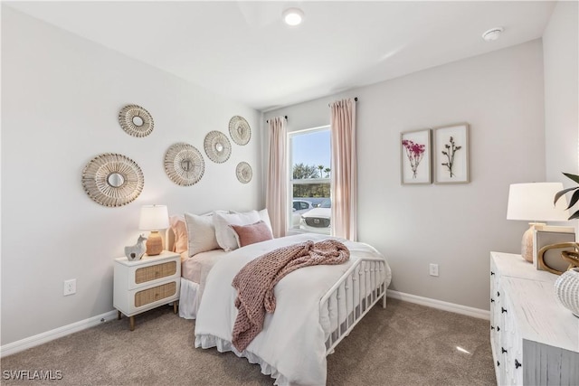 bedroom with carpet and baseboards