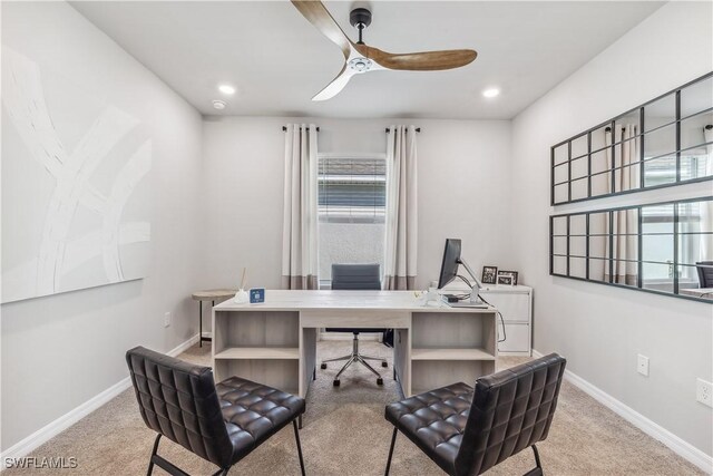 carpeted office space featuring ceiling fan