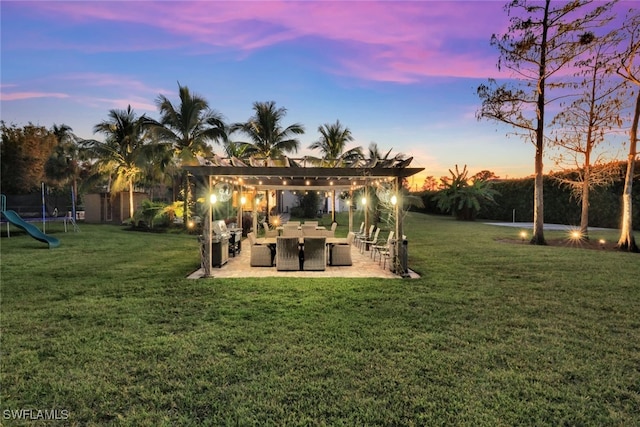 yard at dusk with a pergola, a patio, and a trampoline