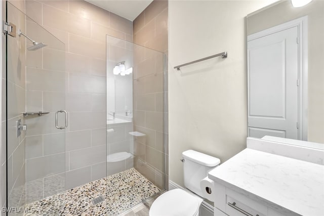 bathroom featuring vanity, toilet, and an enclosed shower