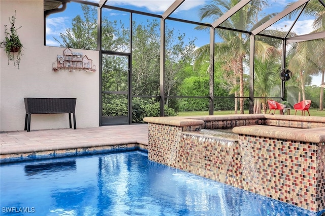 view of pool featuring a lanai, pool water feature, and a patio