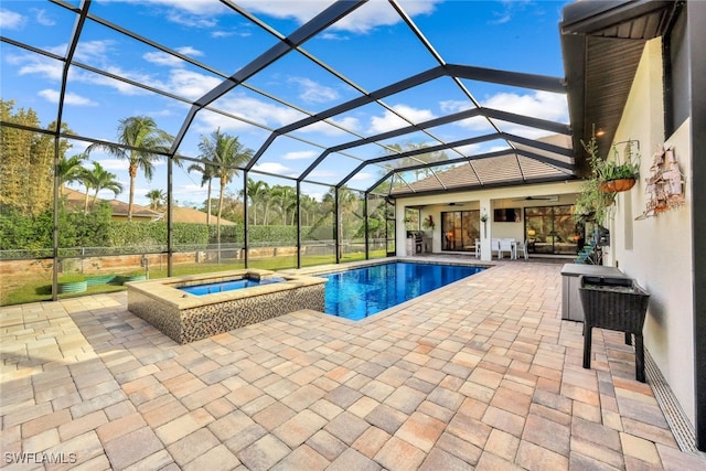 view of swimming pool with a lanai, a patio area, an in ground hot tub, and ceiling fan