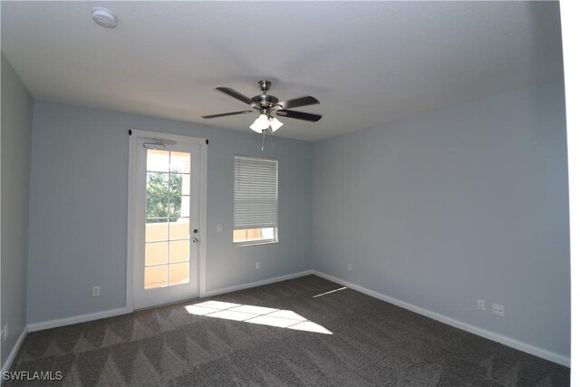 carpeted spare room with ceiling fan