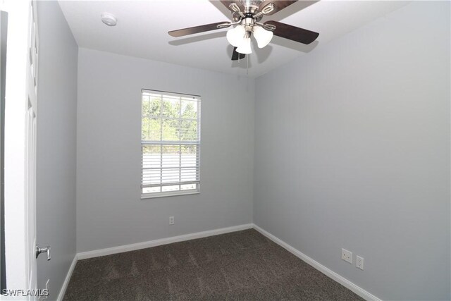 carpeted spare room featuring ceiling fan