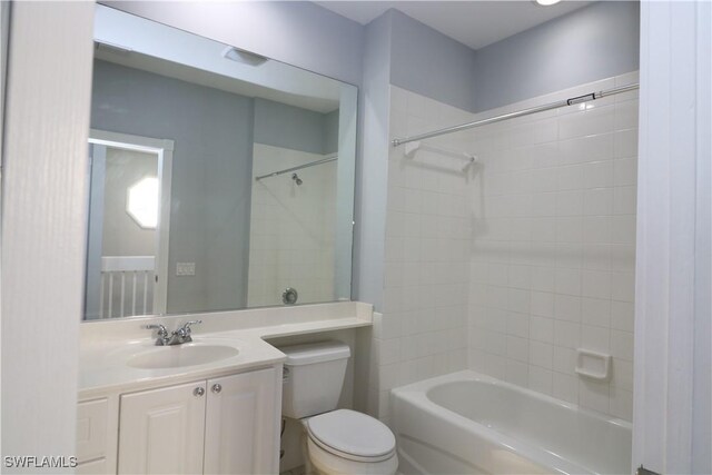 full bathroom featuring vanity, bathing tub / shower combination, and toilet