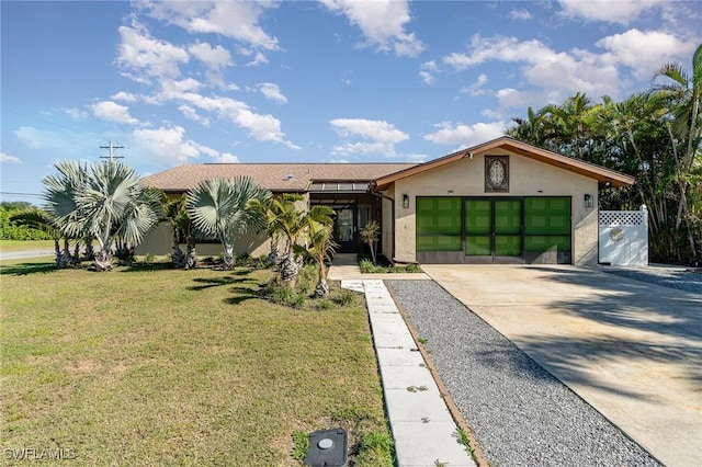 view of front facade with a front yard and a garage