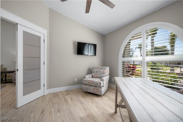 sitting room featuring ceiling fan, light wood-type flooring, and vaulted ceiling