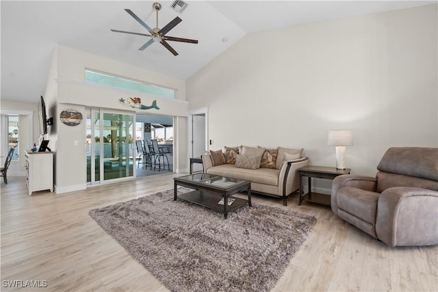 living room with ceiling fan, plenty of natural light, and light hardwood / wood-style flooring