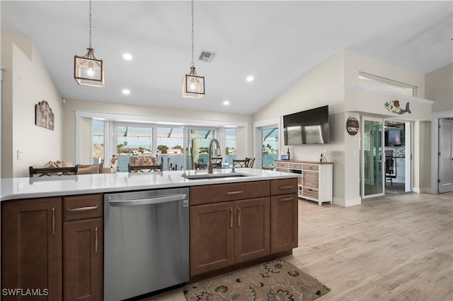 kitchen featuring sink, pendant lighting, light hardwood / wood-style flooring, dishwasher, and lofted ceiling