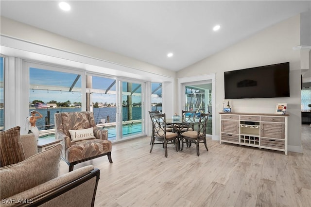 dining room featuring vaulted ceiling and light hardwood / wood-style flooring