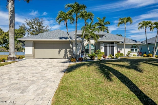 ranch-style house with a front yard and a garage