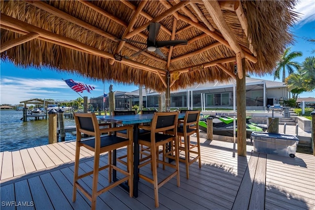 view of dock featuring a gazebo and a deck with water view