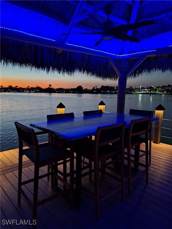 dining area with a water view and wood-type flooring