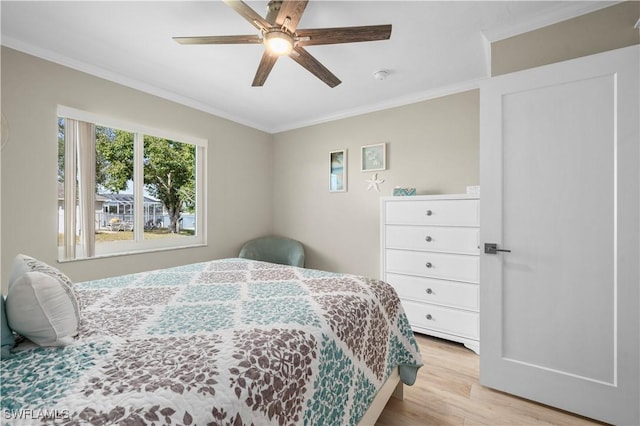 bedroom with ceiling fan, light hardwood / wood-style flooring, and ornamental molding