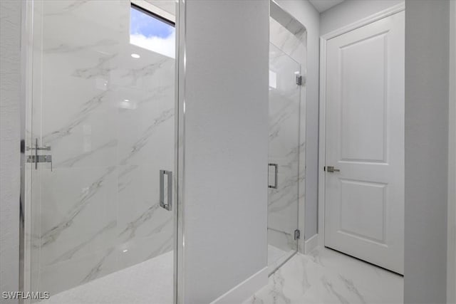 bathroom featuring a shower with door