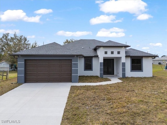 view of front of house featuring a garage and a front lawn