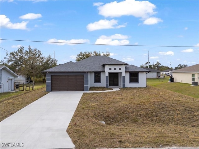 view of front of property featuring a garage and a front yard