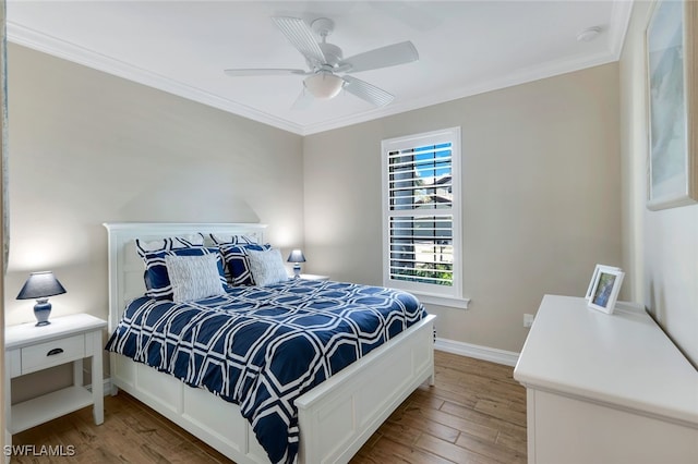 bedroom featuring hardwood / wood-style floors, ceiling fan, and ornamental molding