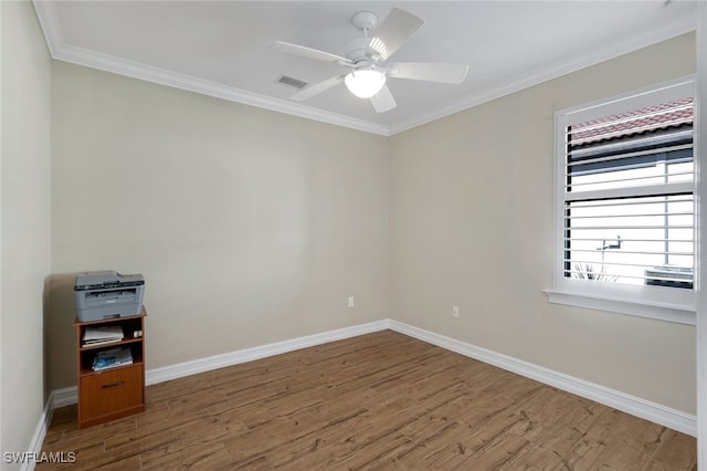 empty room featuring wood-type flooring, ceiling fan, and crown molding