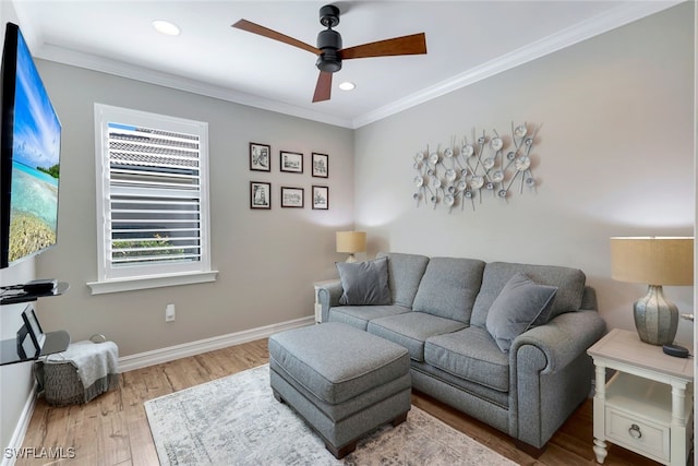 living room featuring hardwood / wood-style floors, ceiling fan, and ornamental molding