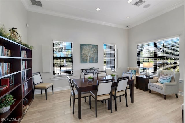 dining room featuring crown molding and light wood-type flooring