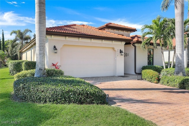 mediterranean / spanish house featuring a garage