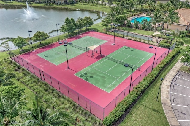 view of sport court with a water view